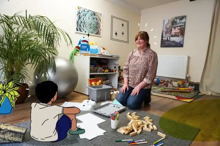 Child and adult therapist sat on the floor